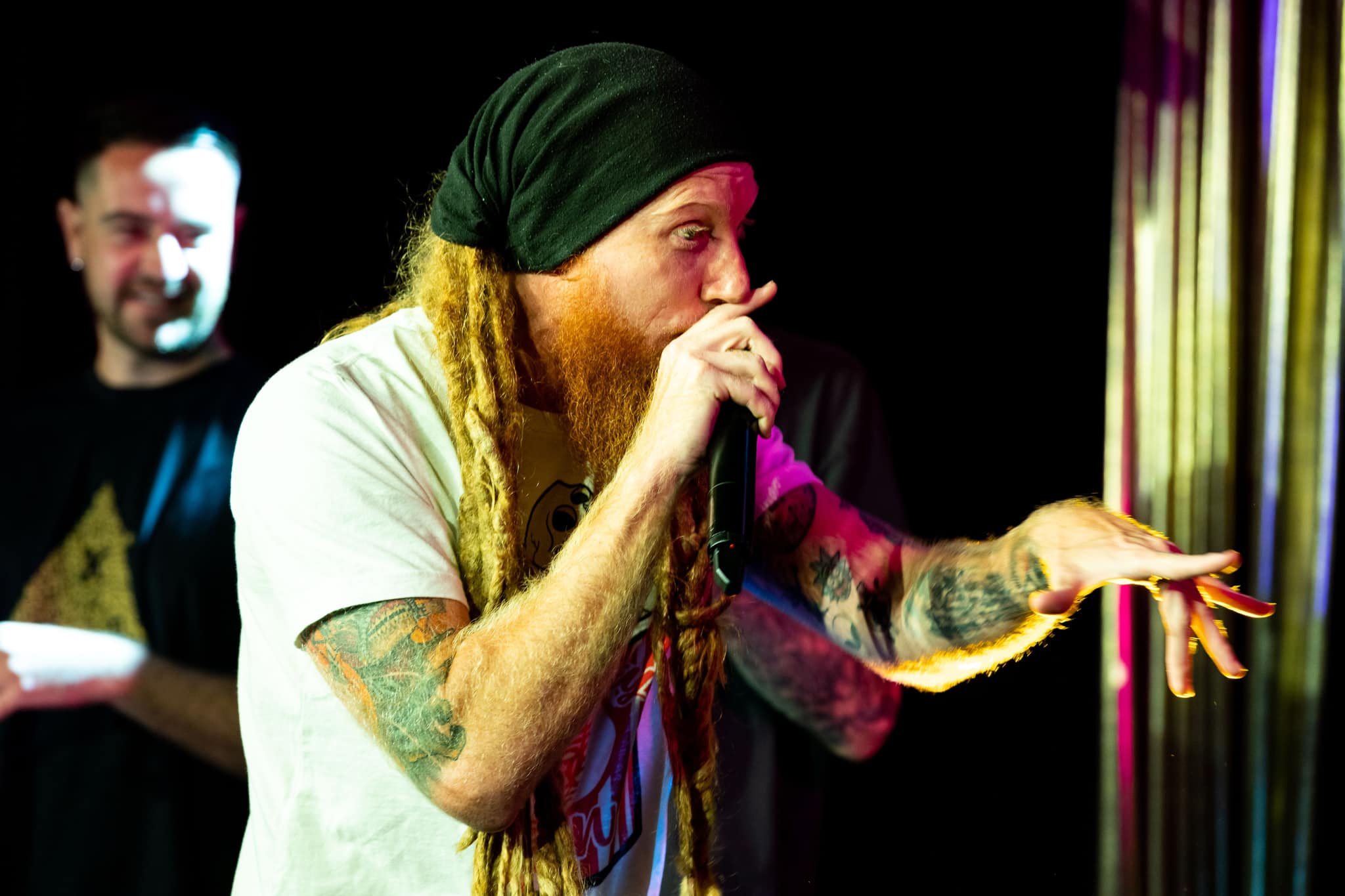 Bluntfield pointing at someone in front with a mic in his hand